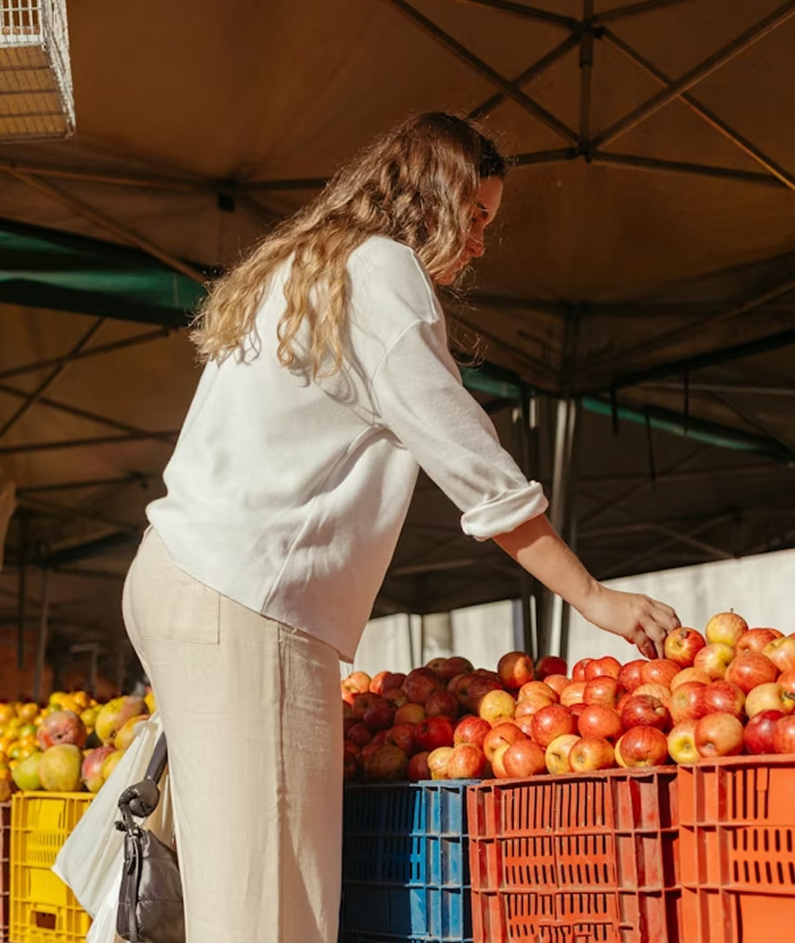 Produce vendor organizing fruit at market