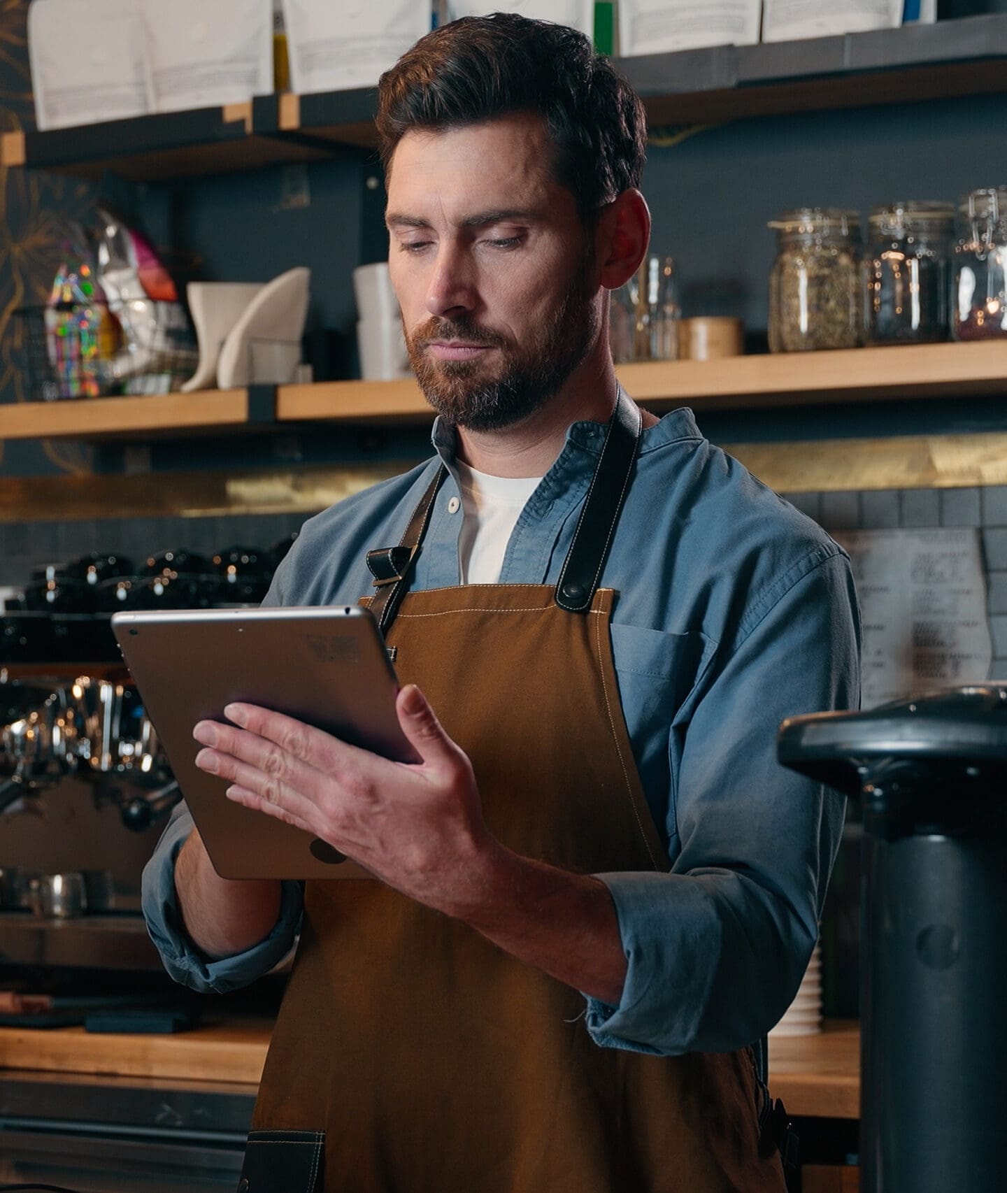 Staff using tablet behind counter