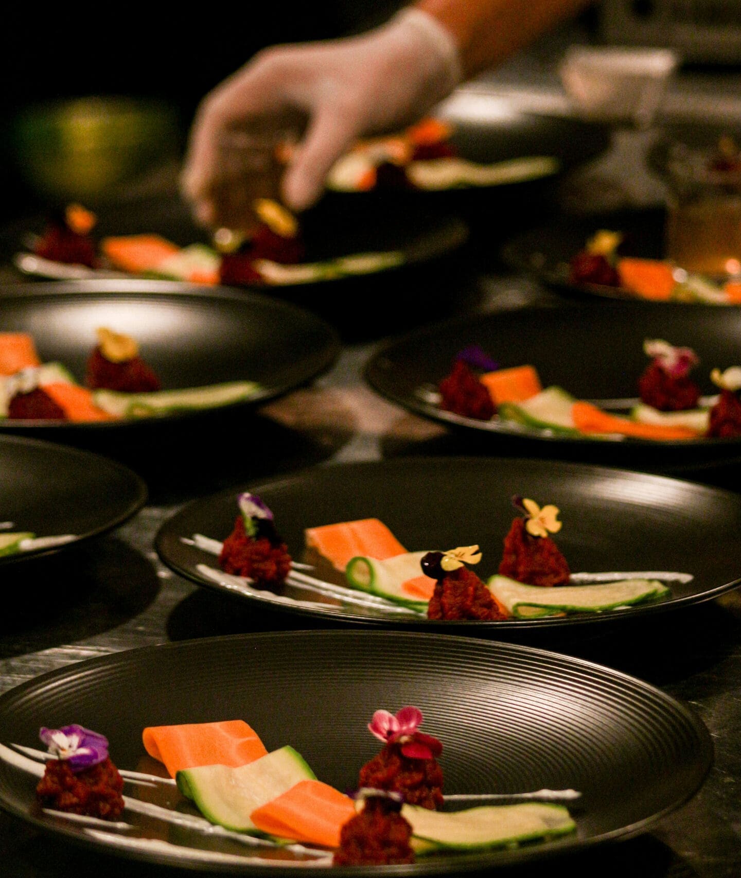 Person preparing plated dishes