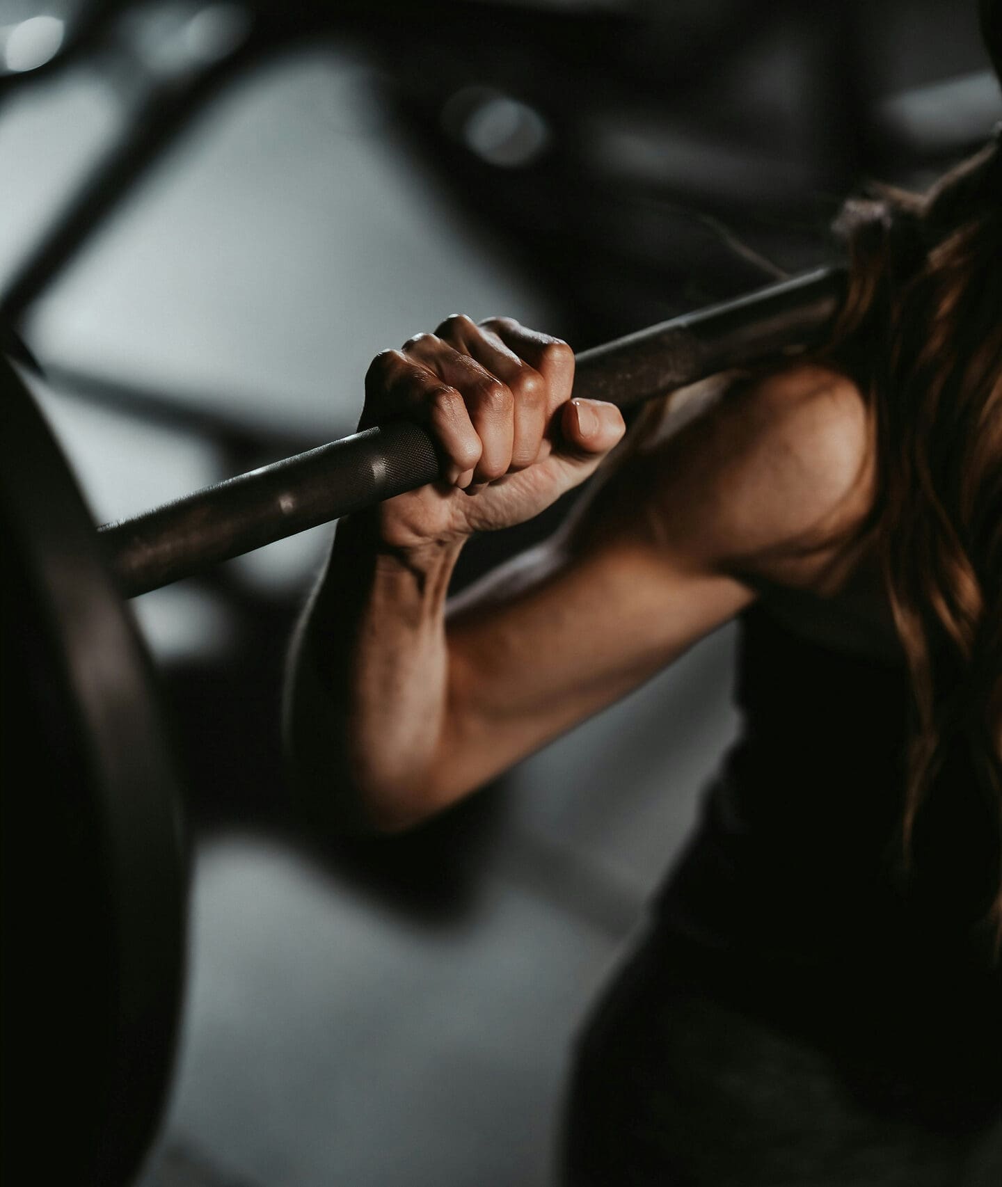 Person performing barbell squat exercise