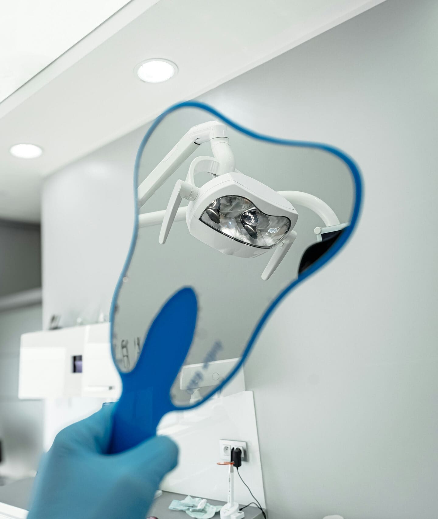 Dentist holding dental mirror and examination tool
