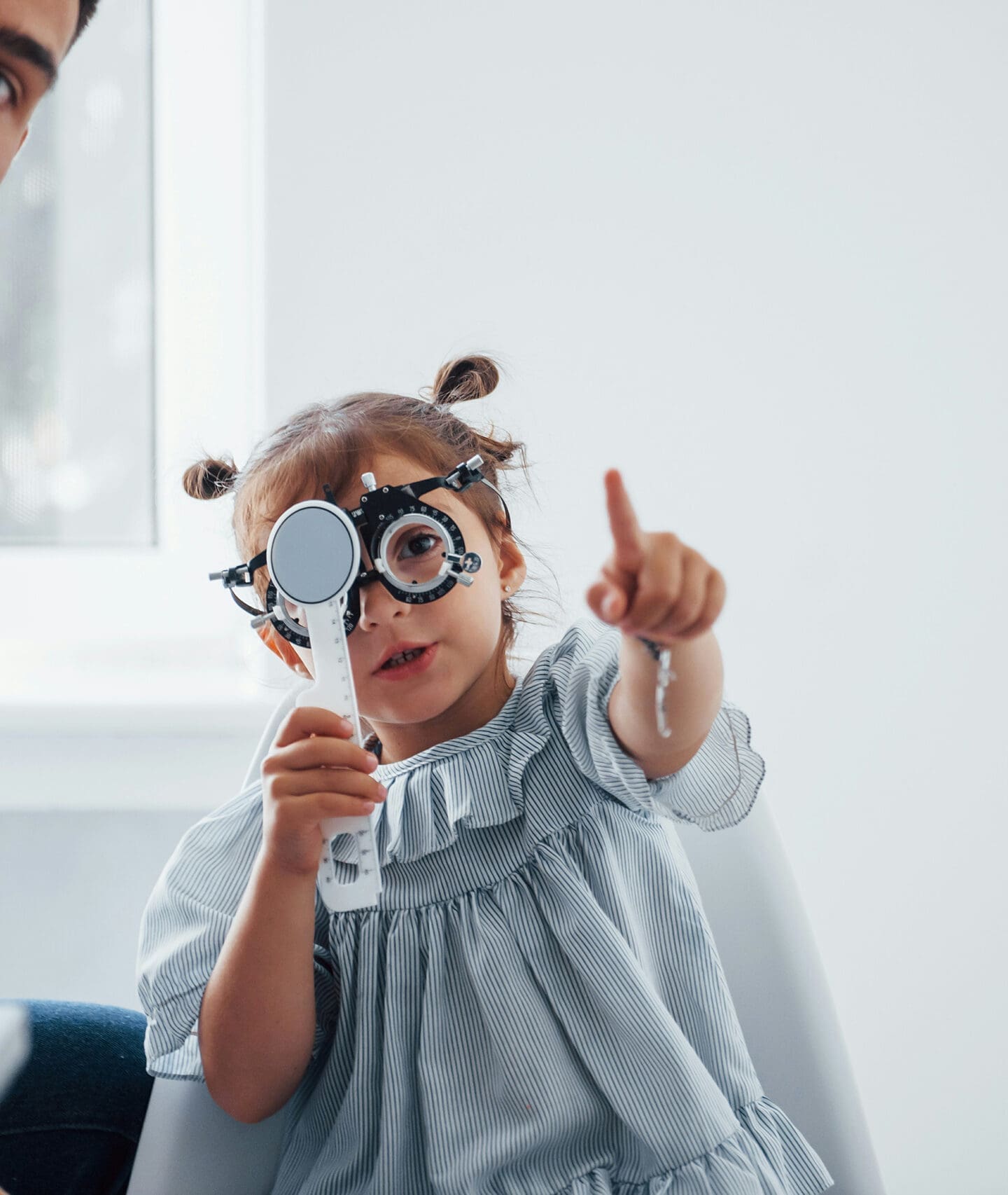 Child using optometry testing lenses during eye exam