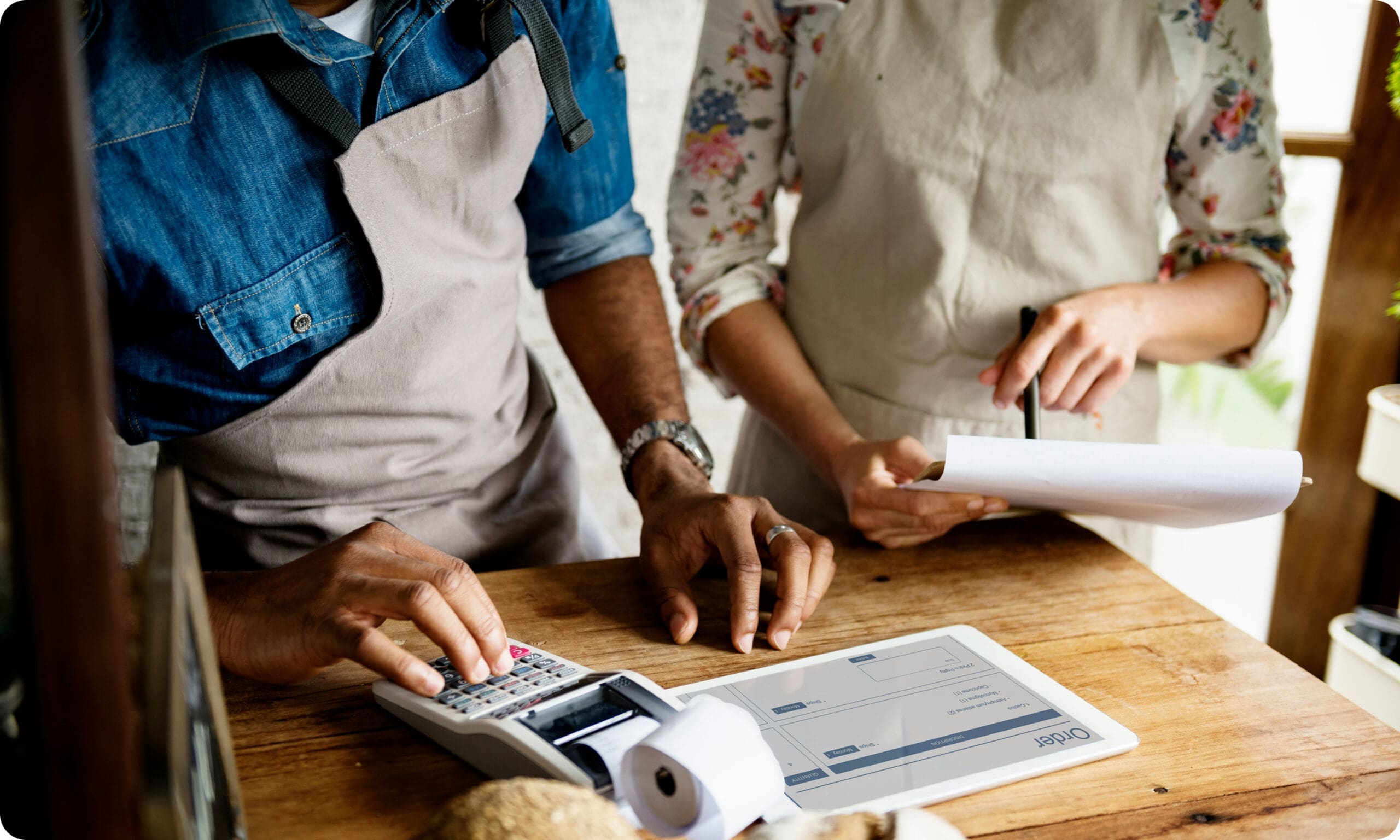 Staff processing payment with countertop terminal