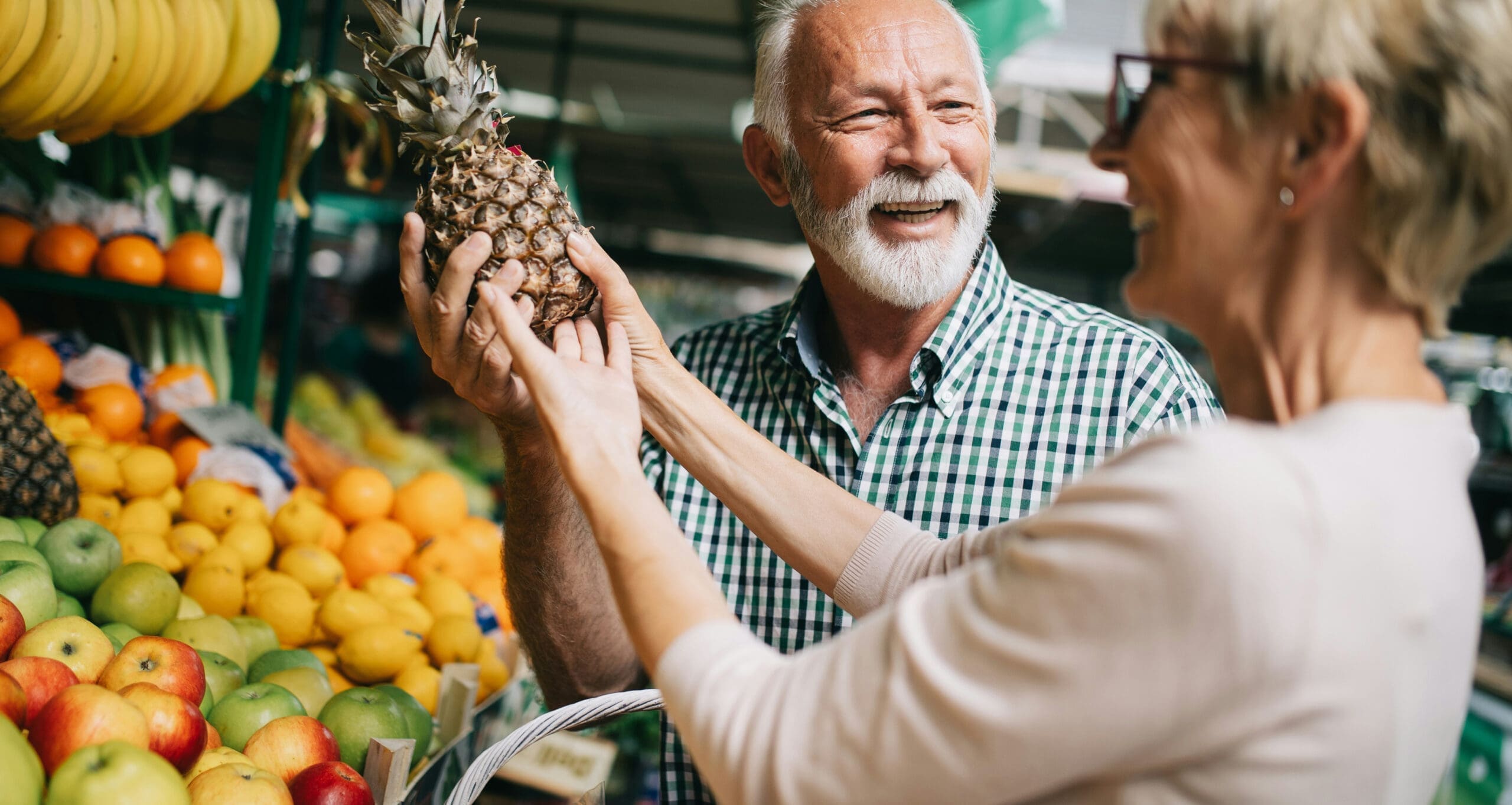 Customers selecting produce at grocery store
