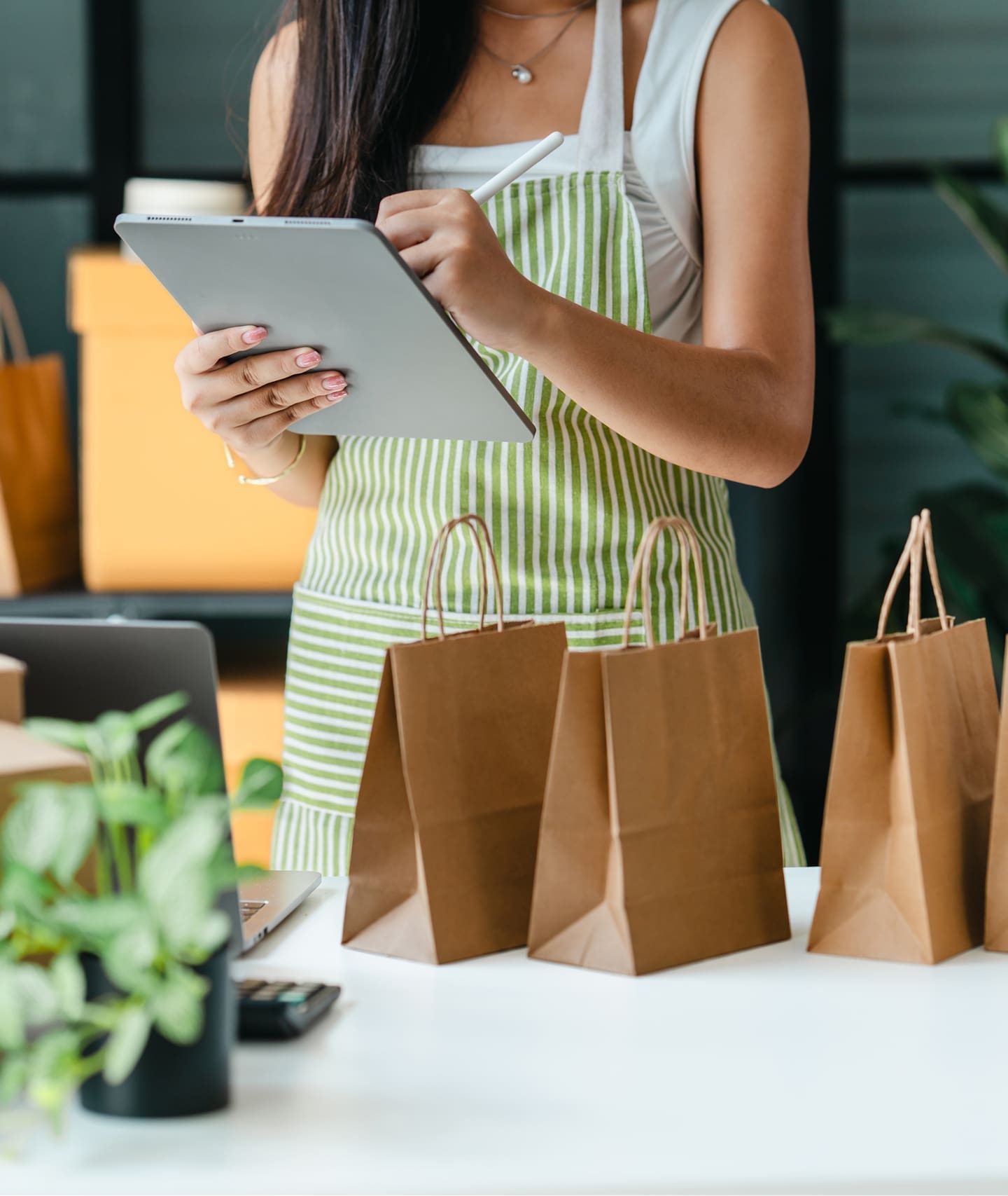 Small business owner preparing customer orders using a tablet