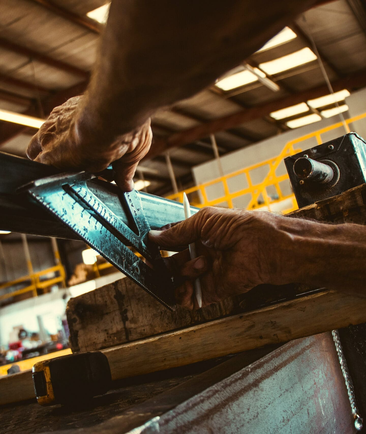 Worker measuring metal beam