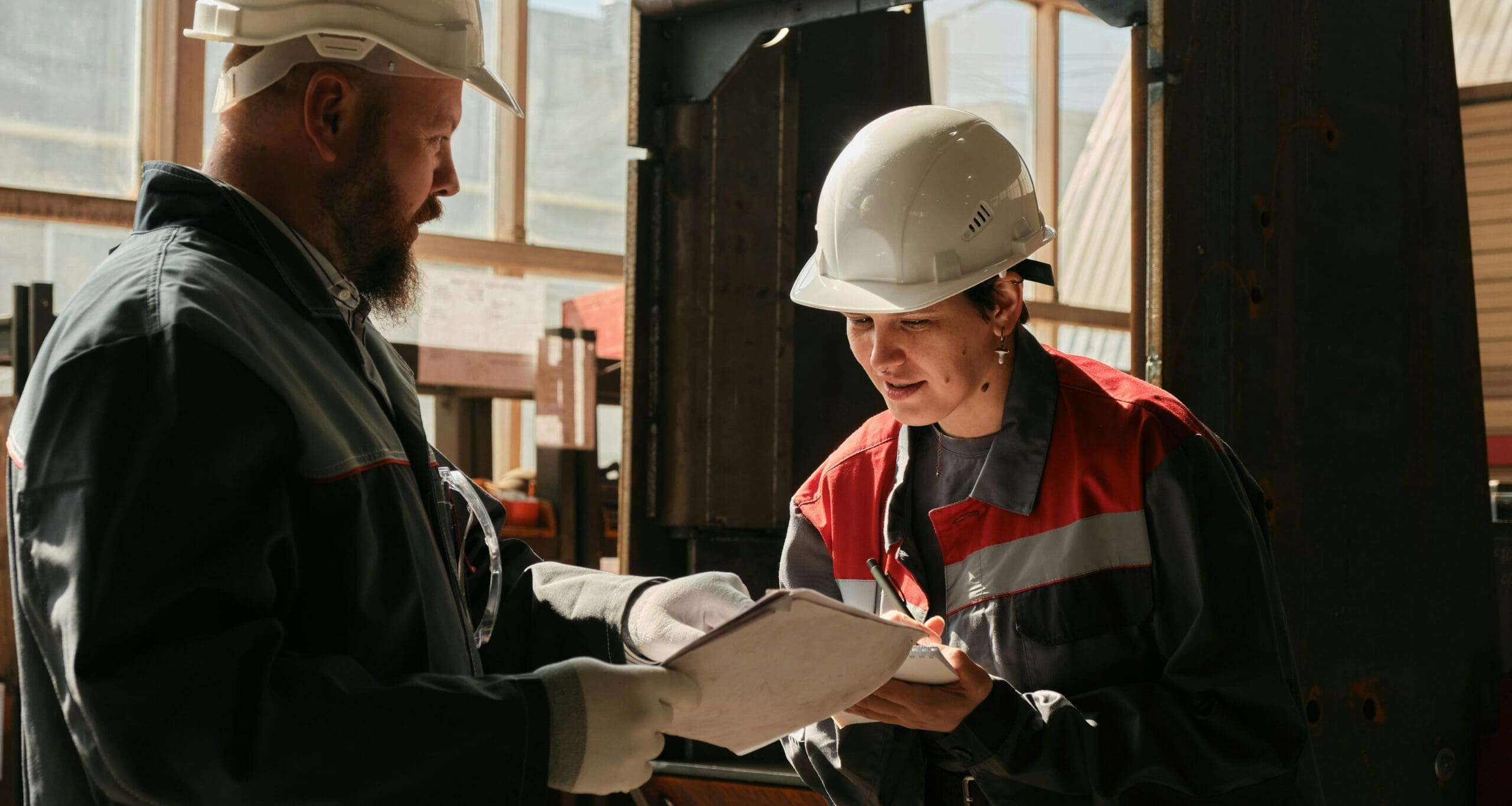 Hard-hat workers reviewing documents