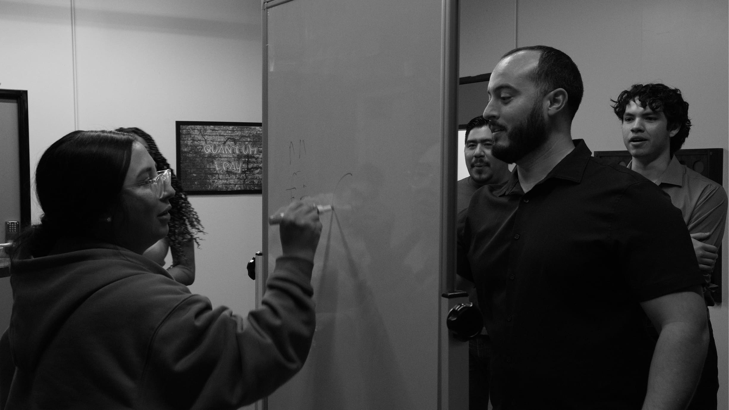 Employees writing on whiteboard