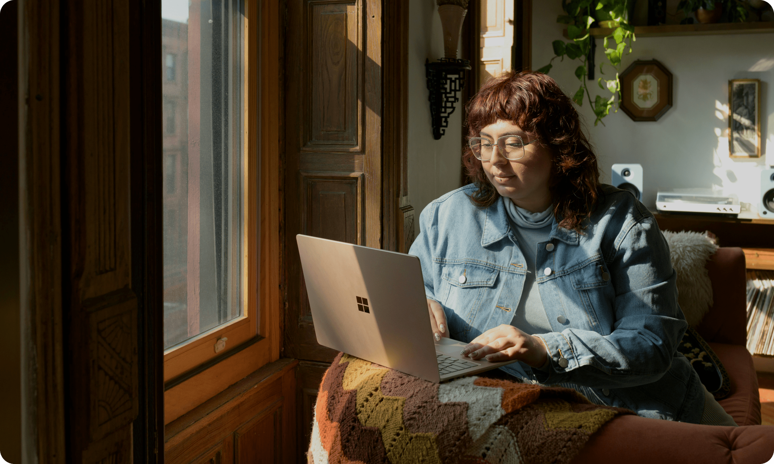 Person working on laptop near window