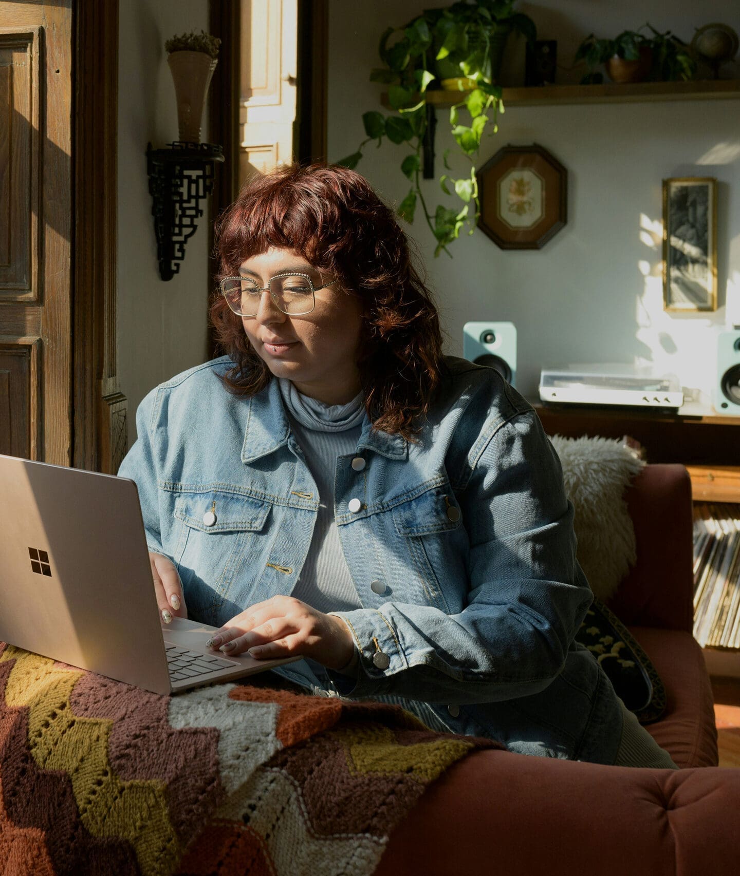 Person working on laptop near window