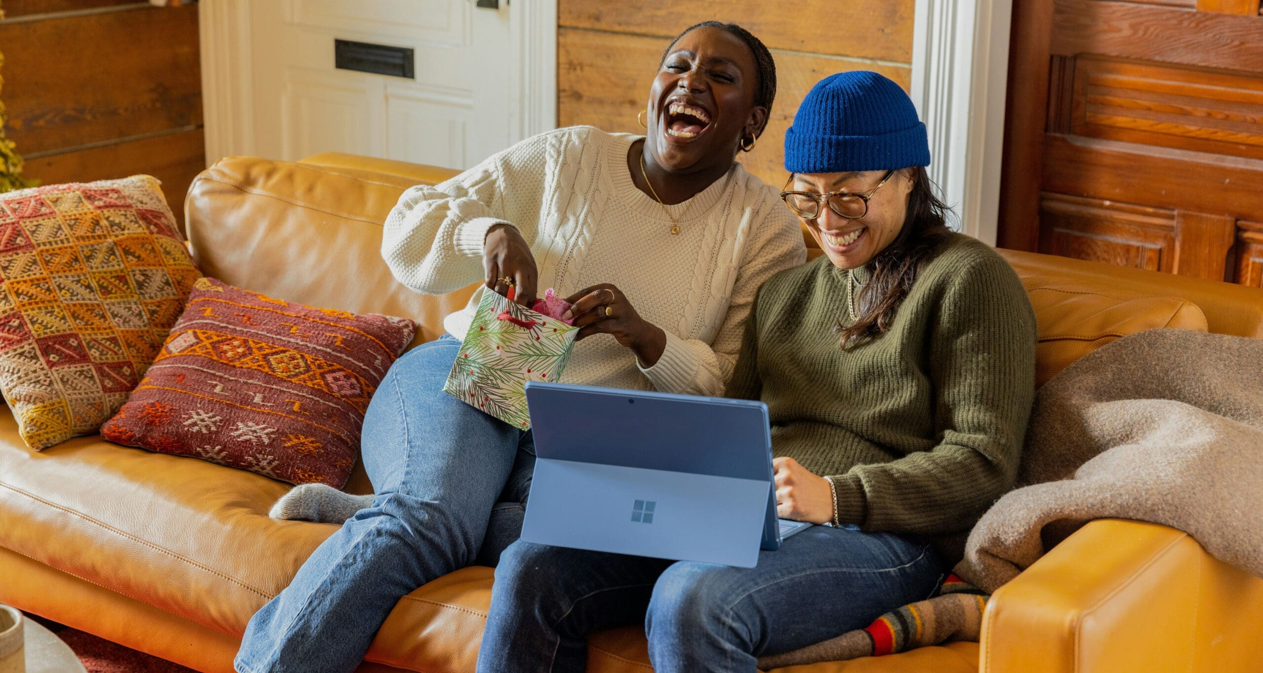 Two people laughing on couch