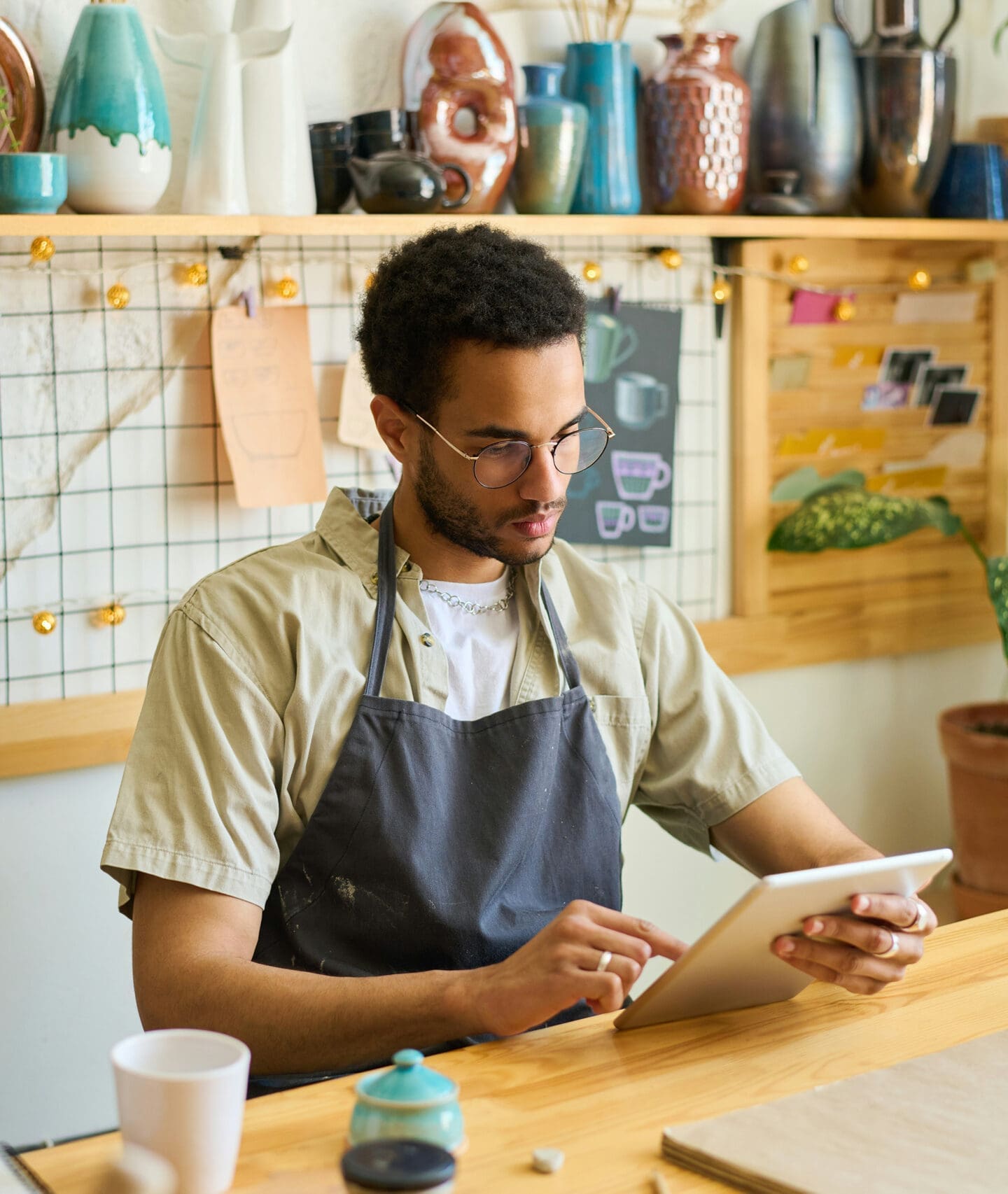 Business owner writing notes at workbench