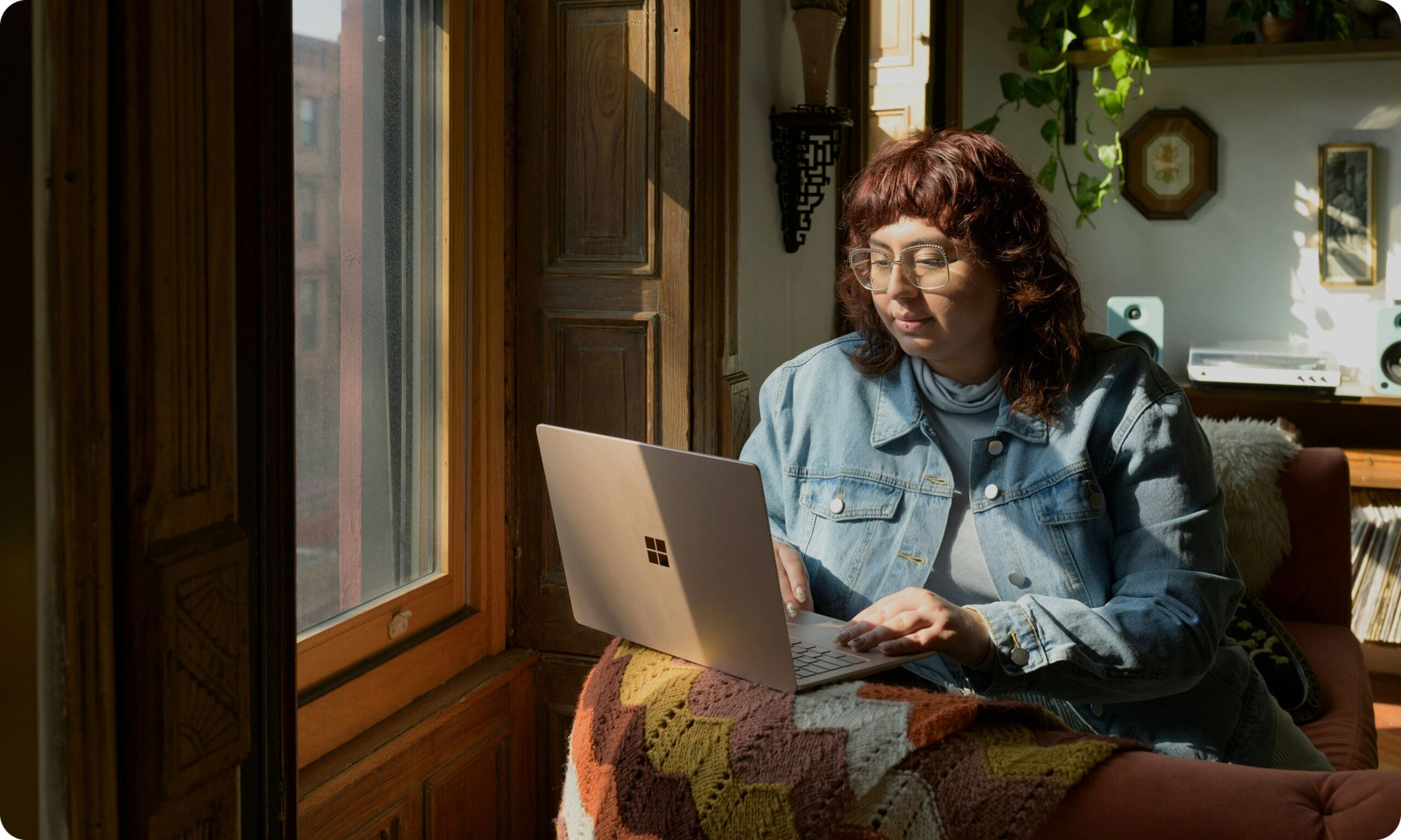Person working on laptop near window