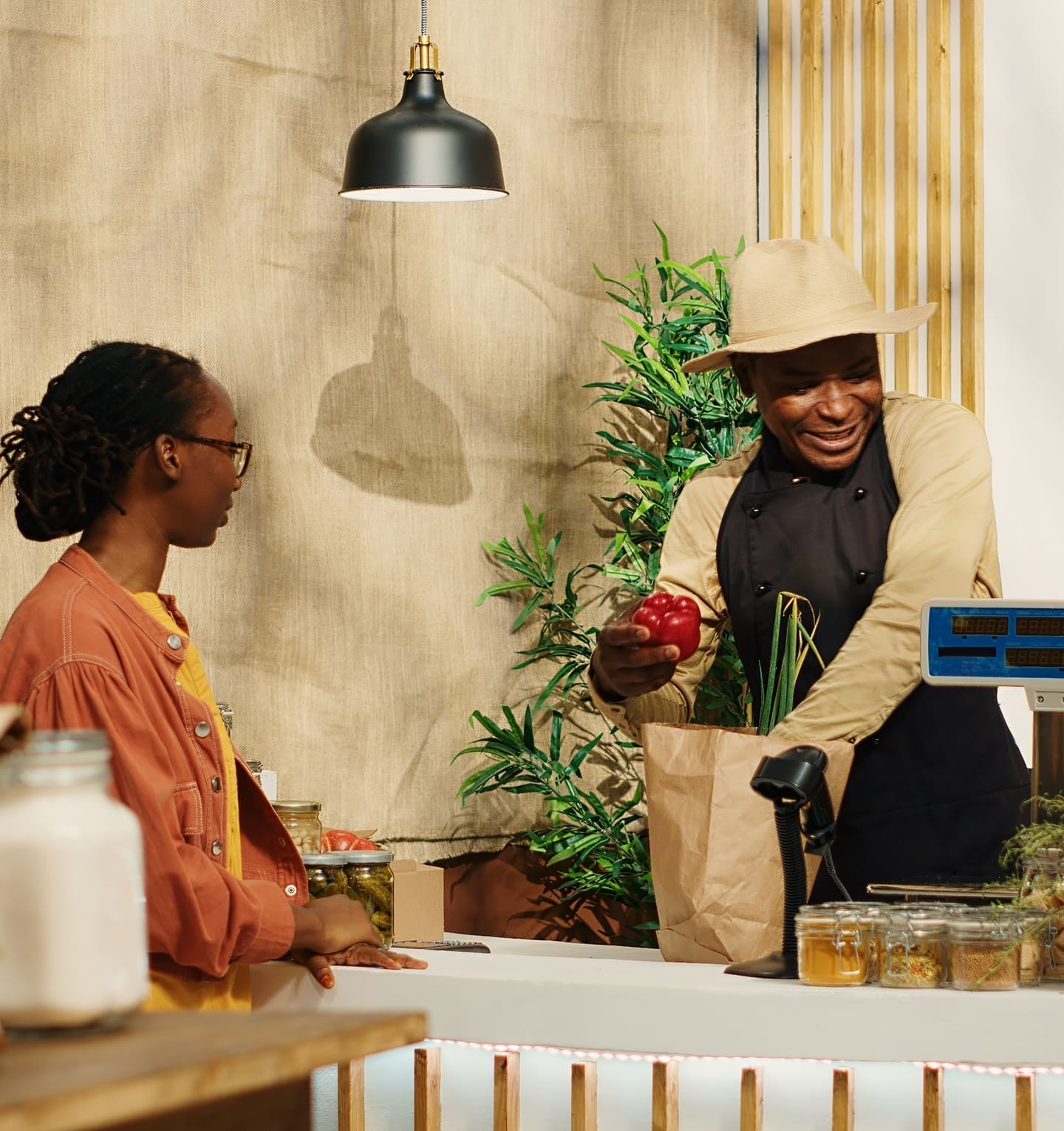 Small business owner serving customer at retail counter