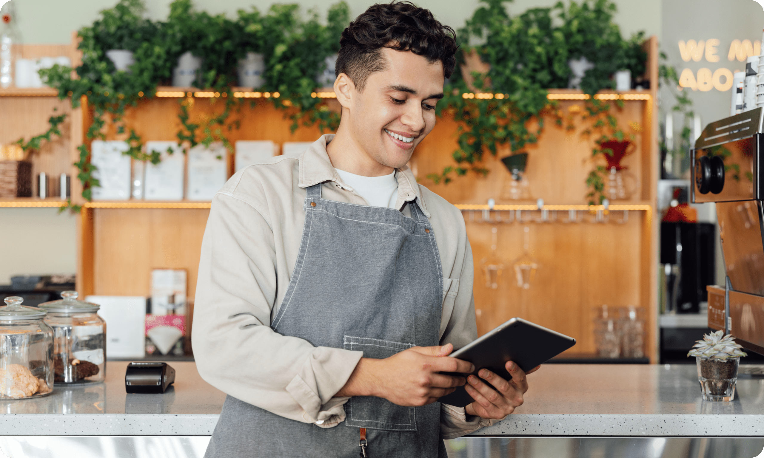 Retail merchant using tablet behind store counter