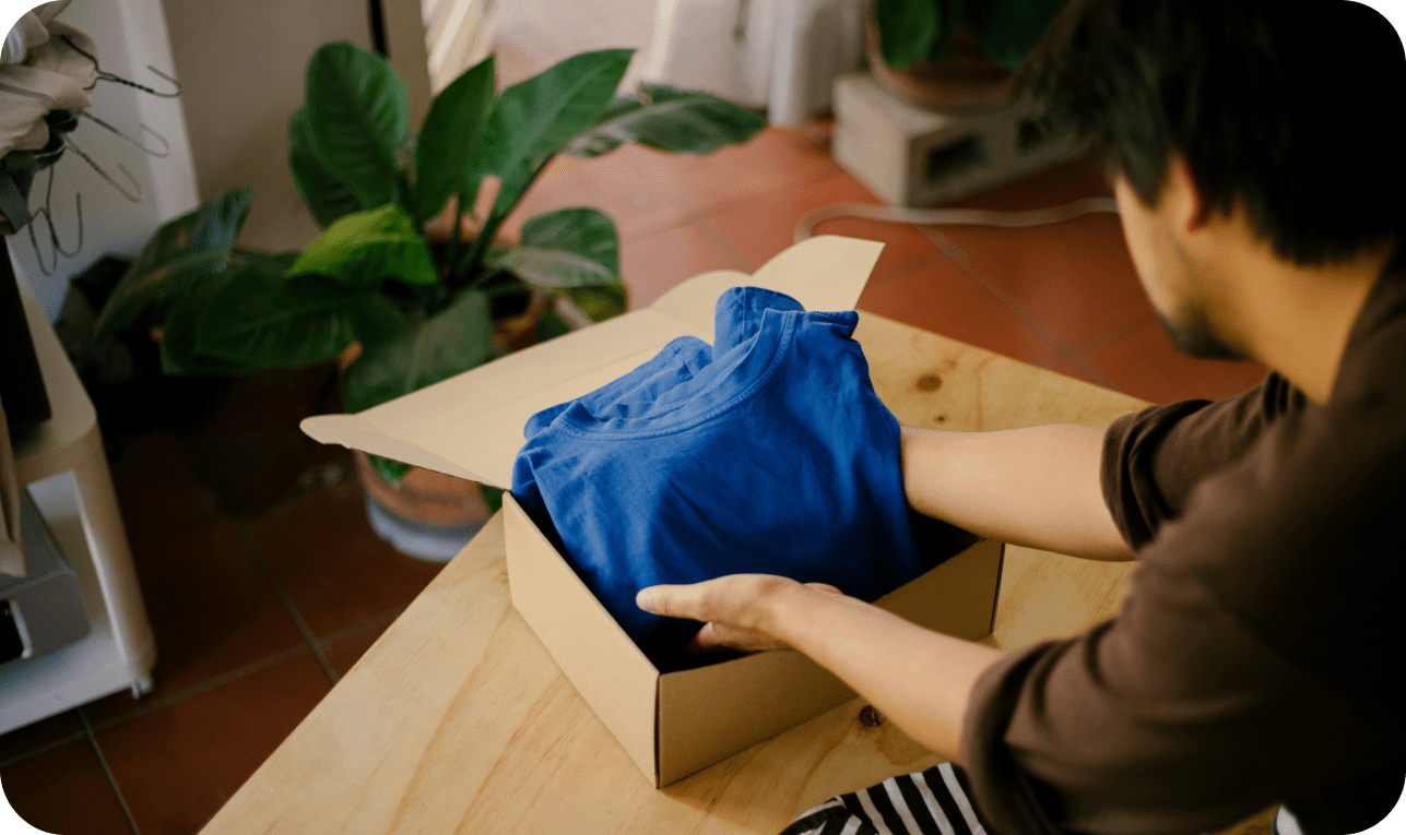 Packing clothes into shipping box