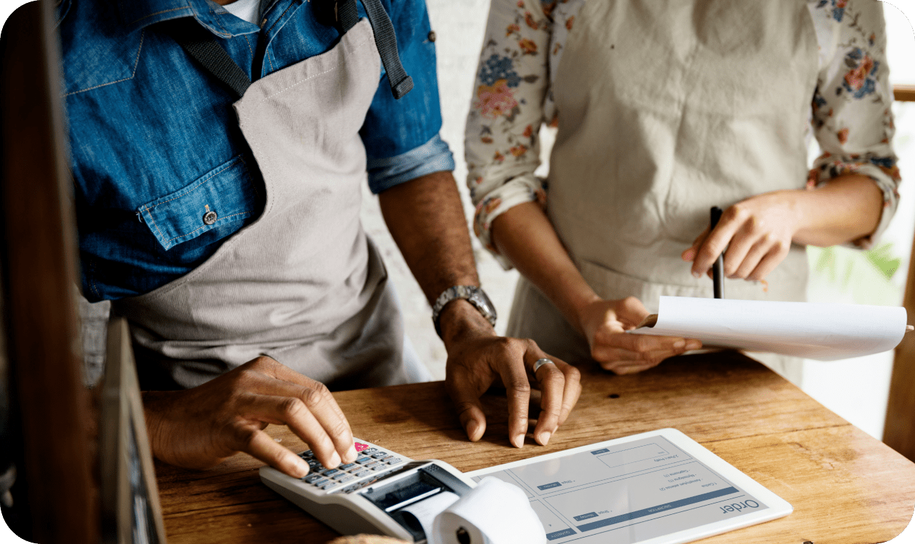 Staff processing payment with countertop terminal