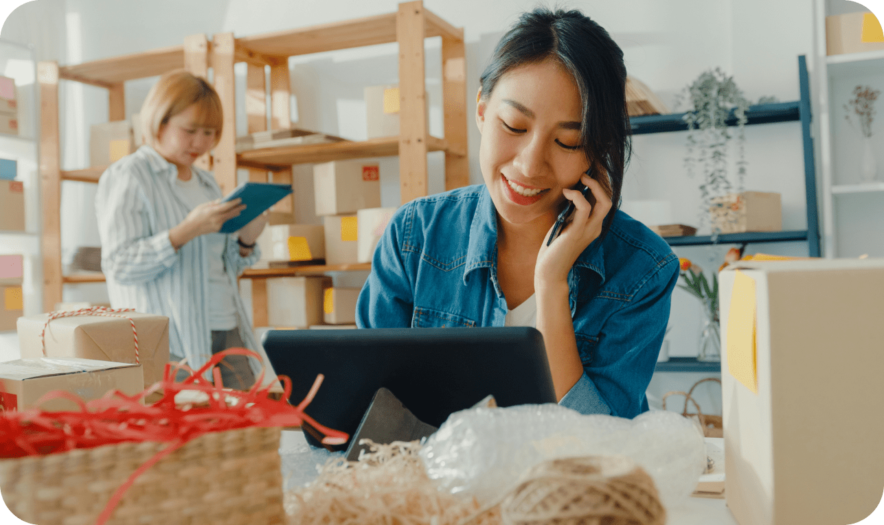 Small business owner managing orders at workspace