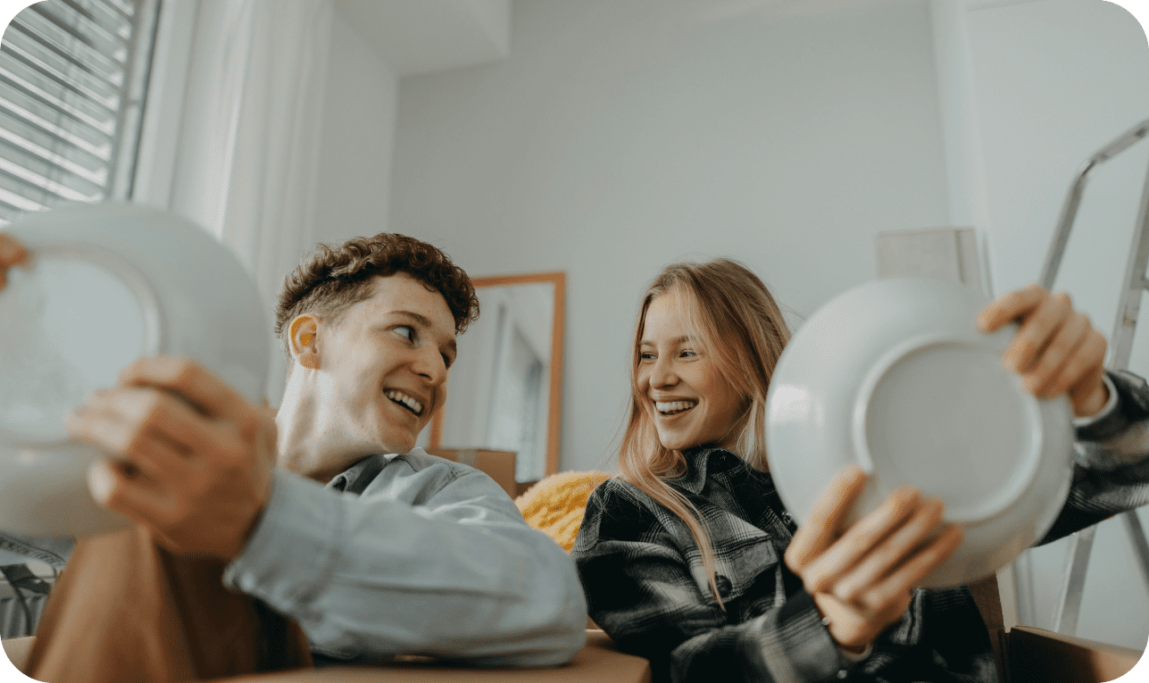 Two people holding plates and smiling