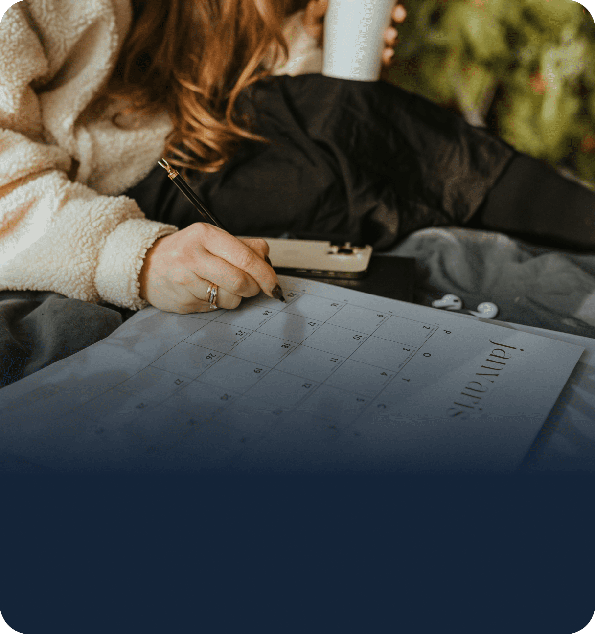 Person reviewing calendar schedule on desk