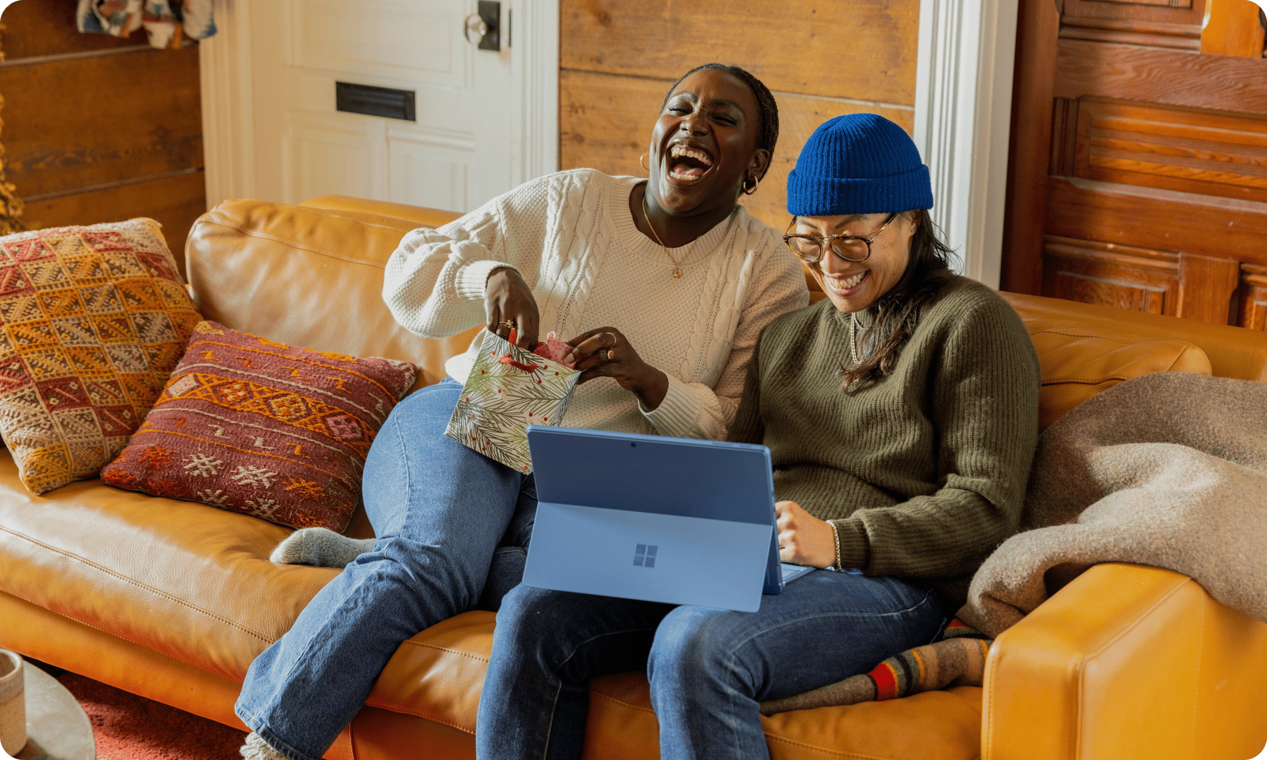 Two people laughing on couch